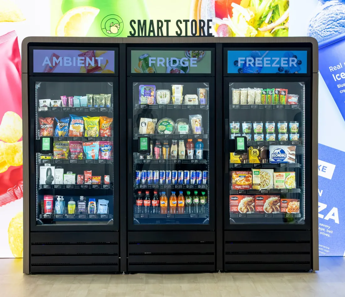 Three-door smart store with ambient, fridge, and freezer sections under one wood-trimmed enclosure